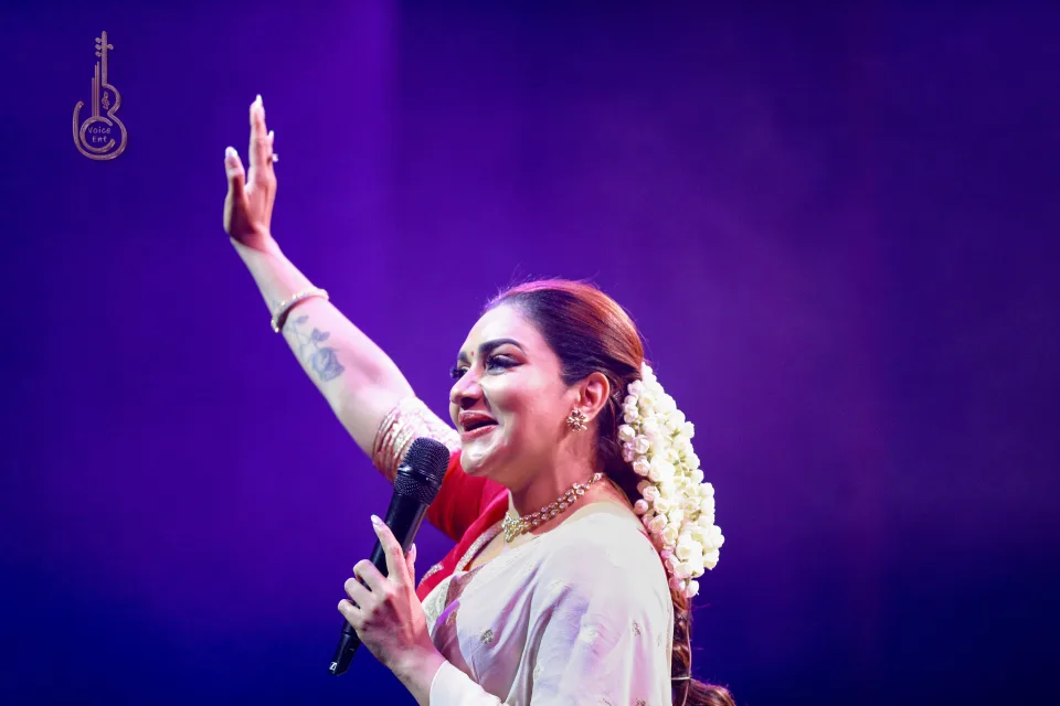 Singer greeting the audience during a BC Voice live performance