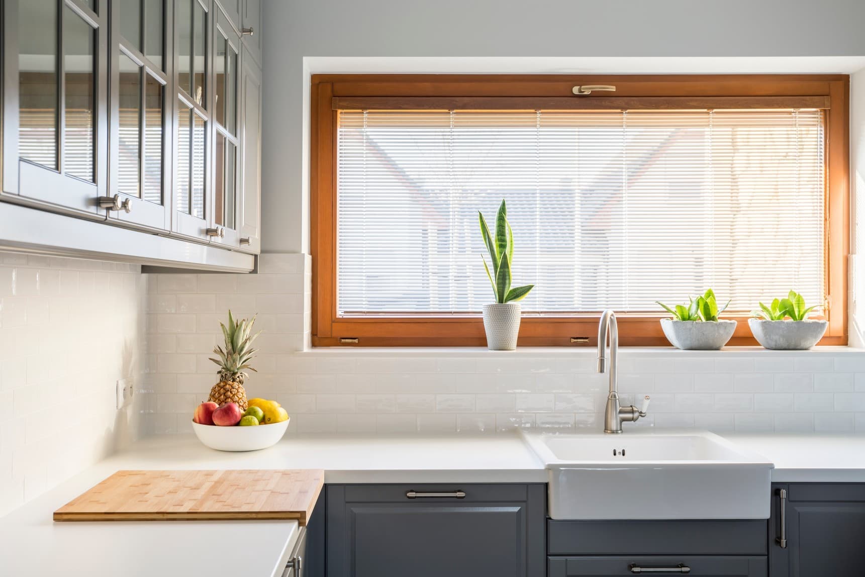 Custom window blinds installed in a bright kitchen